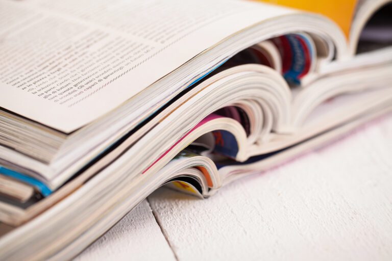 Pile of colorful magazines on a table